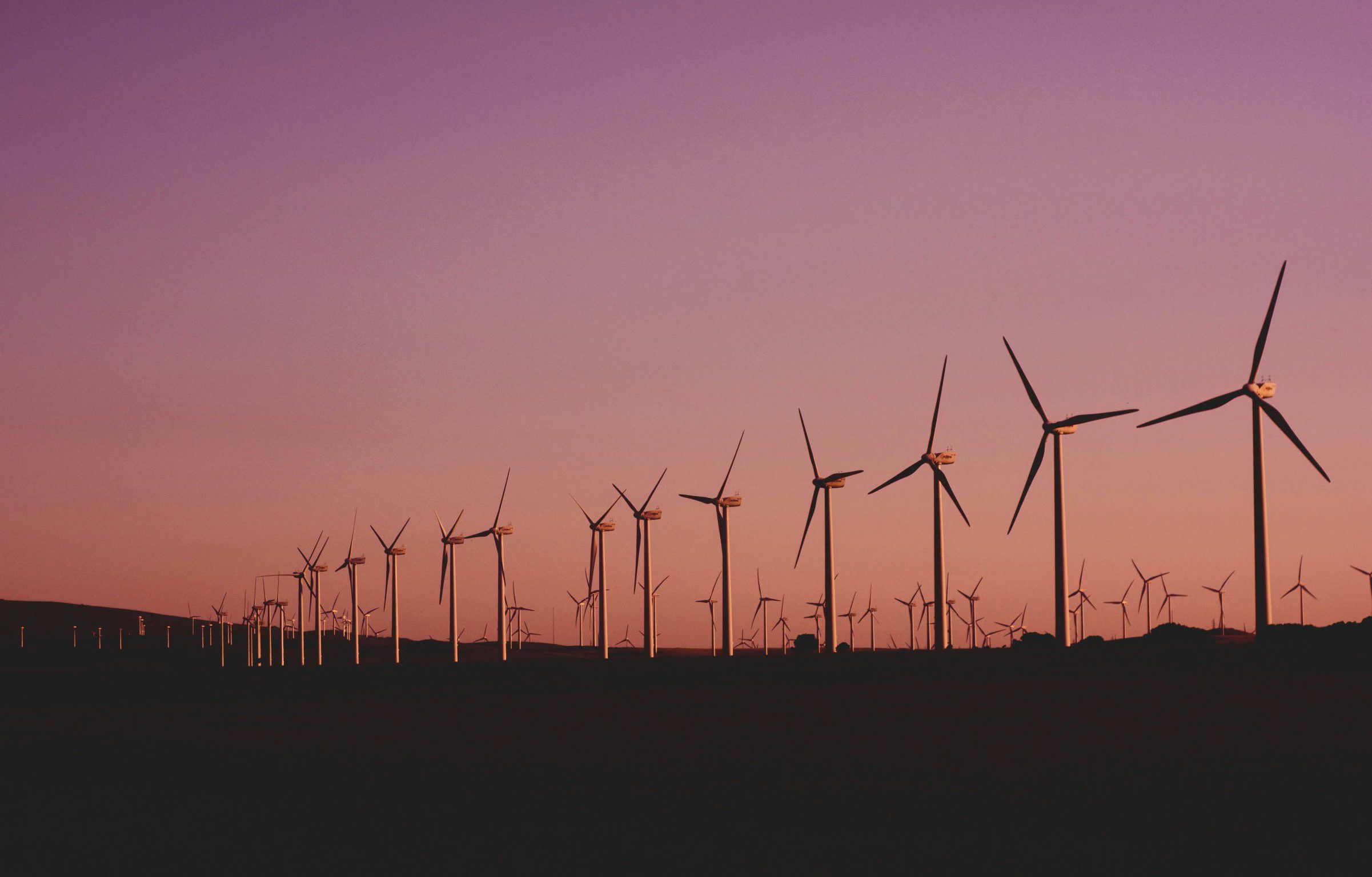 Silhouetted wind turbines at sunset in Zahara de los Atunes, Spain.